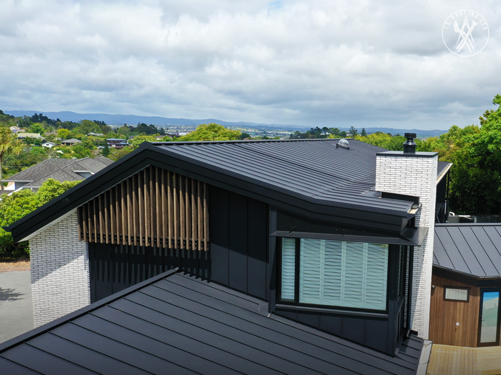 A new black standing seam metal roof on a modern, architecturally designed NZ home, showcasing a premium roofing solution.